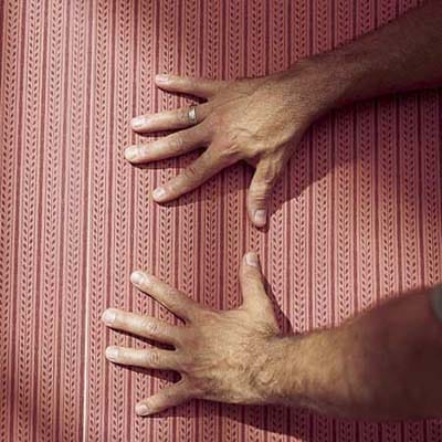 using hands to pop a wallpaper bubble