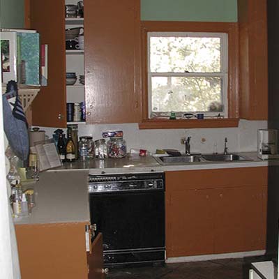Original cramped kitchen with tobacco-brown cabinets and poor ventilation.