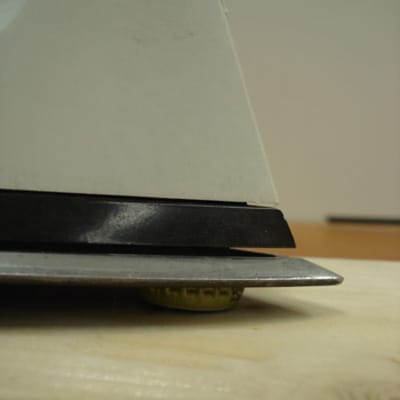 A bottle cap under a piece of trim