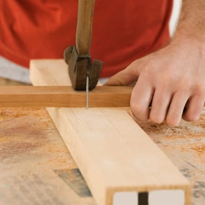 Using a hammer to pull out nails