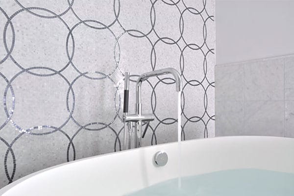 Image of a bathroom with a large mosaic tile pattern on the wall