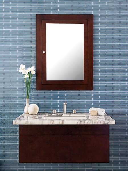 Image of a bathroom vanity on a mosaic tile wall