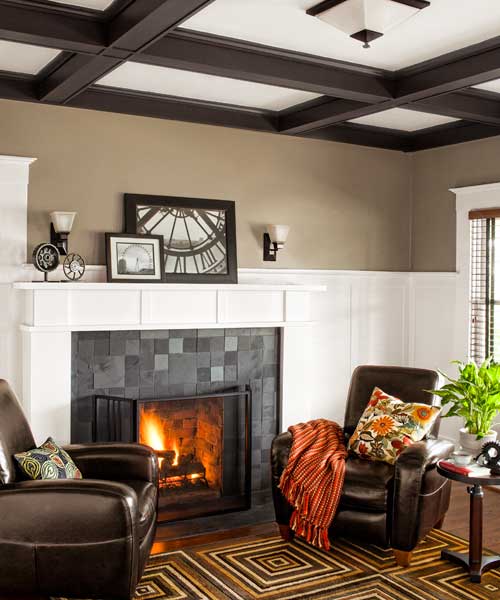 A living room with a lit fireplace