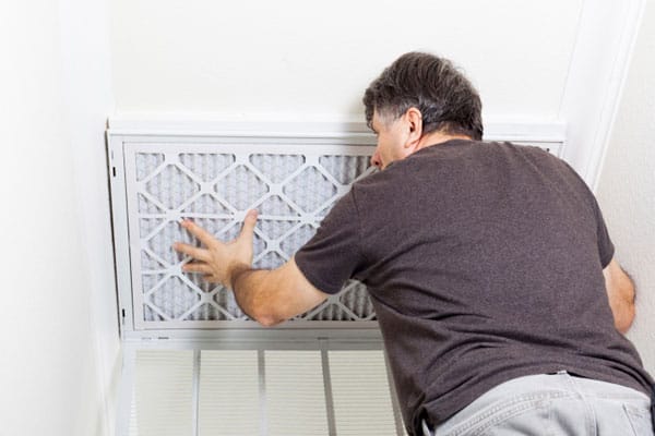 A man changing a home air filter