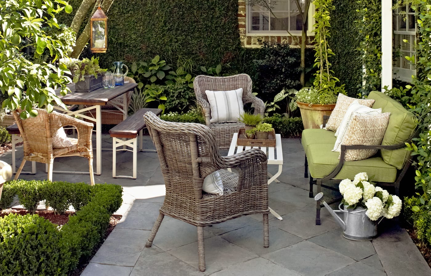 Outdoor patio with light weight whicker furniture which can be easily moved around. 