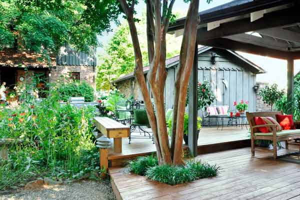 A deck with a cut out for a tree to grow through.