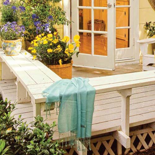 A deck with a bench border.