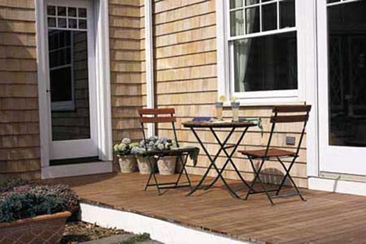 A small deck with patio furiture.