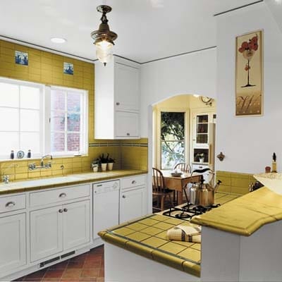Corn-colored tile backsplash with white cabinets.