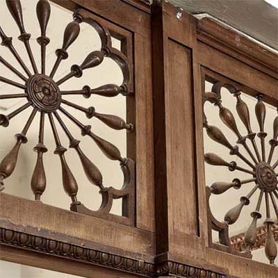 Oak fretwork dividing rooms on parlor floor showing mass-produced Victorian details.
