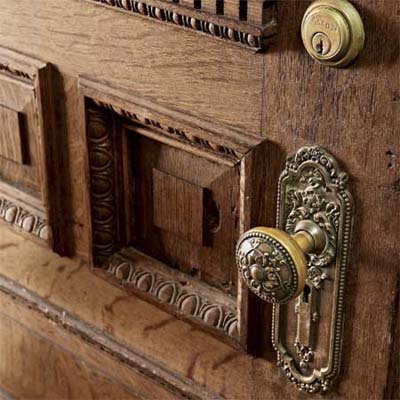 Ornate inner vestibule door with raised panels, egg-and-dart trim, and decorative hardware.