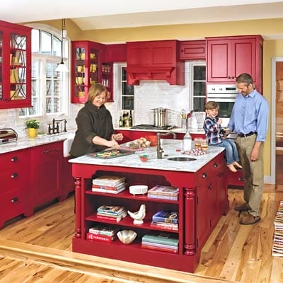 Homeowners in their red kitchen.