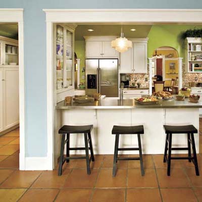 Three black bar stools at a kitchen peninsula.