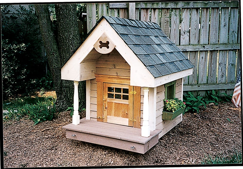 Cozy Colonial dog house with window boxes and bone-shaped gable cutout.