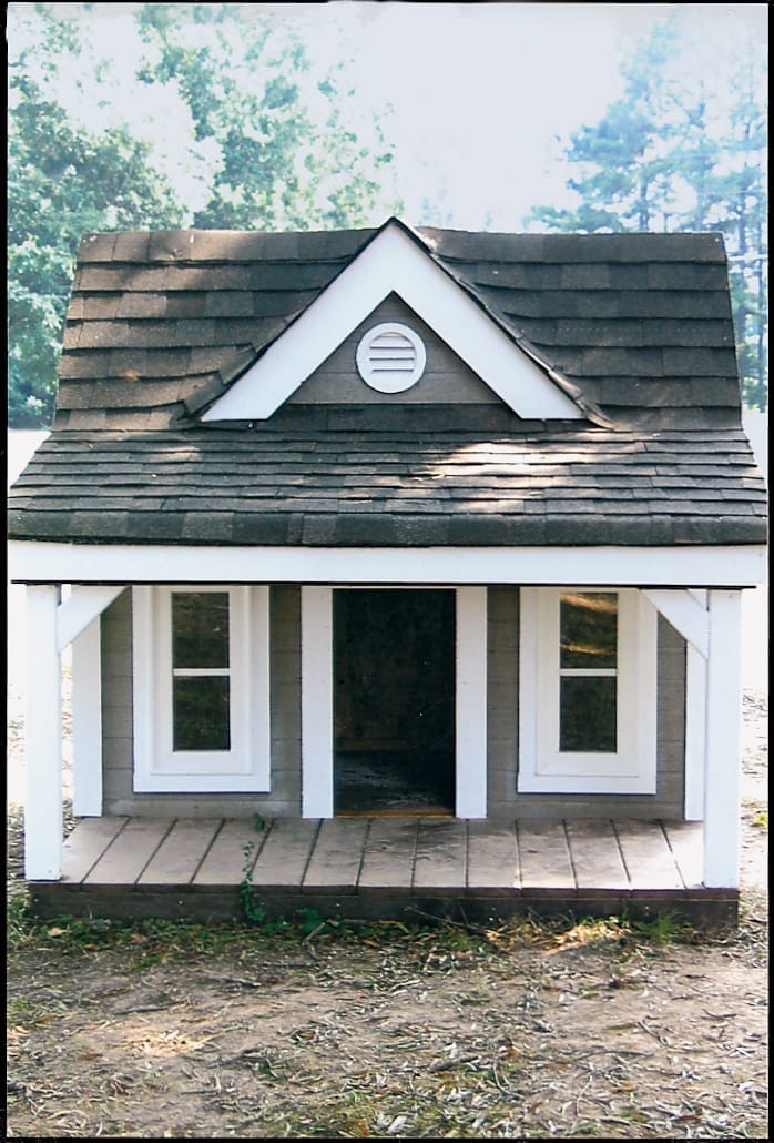 Southern-style doghouse with broad shaded front porch.