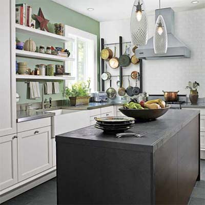 Kitchen with black island and open shelving.