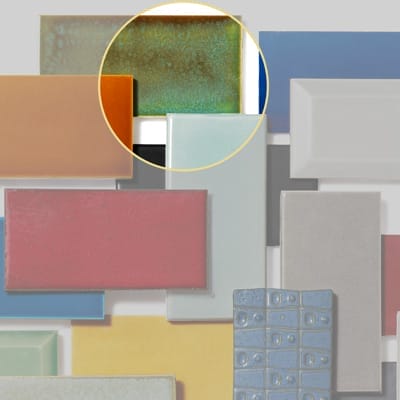 Green and bronze subway tile with organic forest-colored finish.