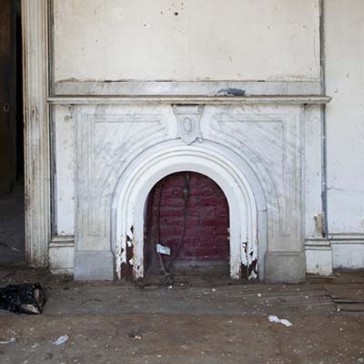Solid marble fireplace mantel surviving renovation process.