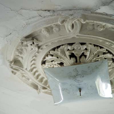 Ornate plaster ceiling medallion requiring restoration or replication.