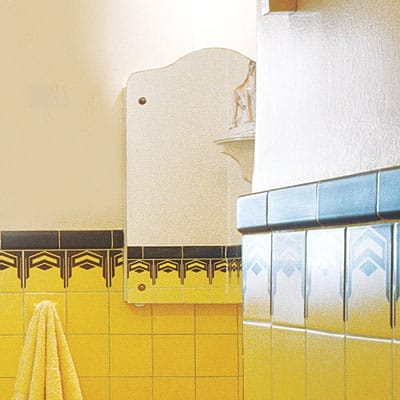 Reflective finishes match the bathroom's vintage art deco style.