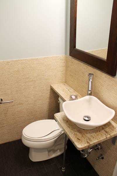 A connected toilet and sink in a small bathroom.