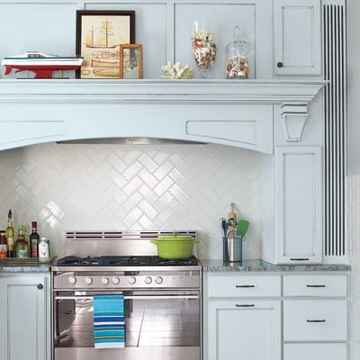 Kitchen stovetop with arched range hood cover.