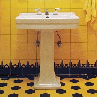 Streamlined sink that is modern technology but matched the vintage art deco style.