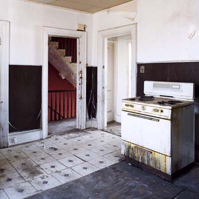 Grimy second-floor kitchen to be converted into bedroom.