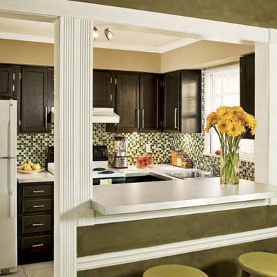 Budget kitchen with glass-tile mosaic backsplash and brown cabinets.