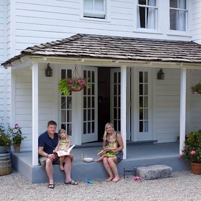 The family sitting on their porch