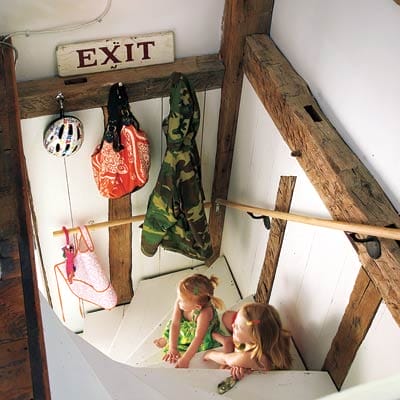 Two children sitting on the interior staircase