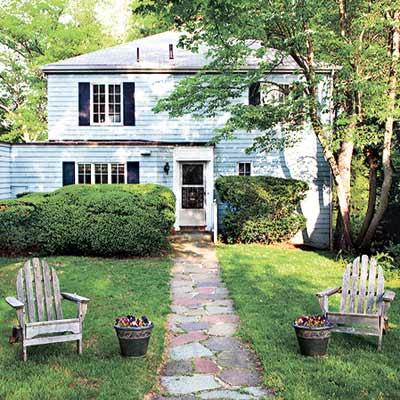 Exterior before renovation showing the facade of a 1940 Colonial Revival house.