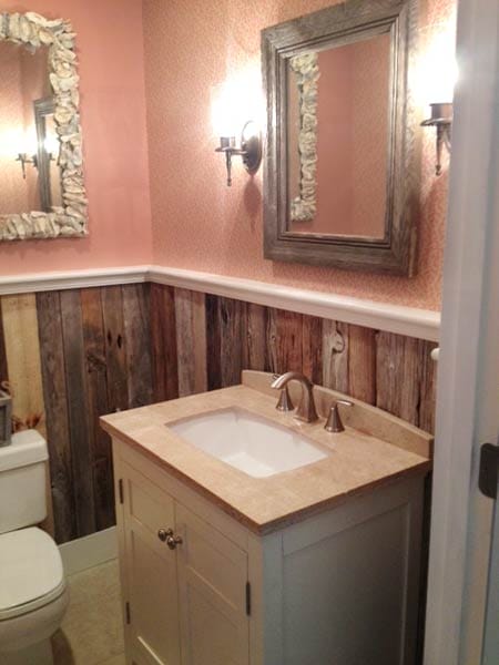 A bathroom with rustic driftwood wainscotting.