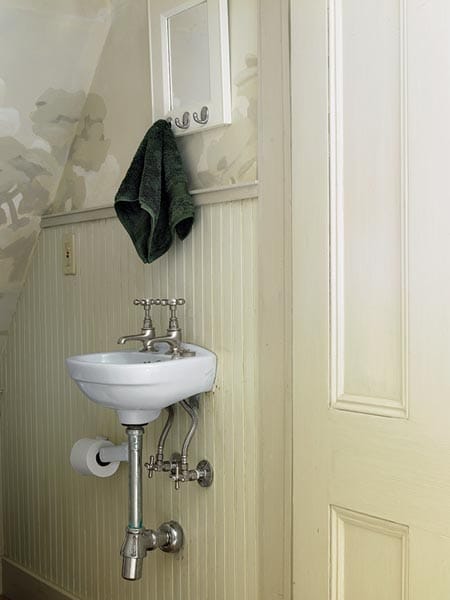 A small bathroom with a really small sink.