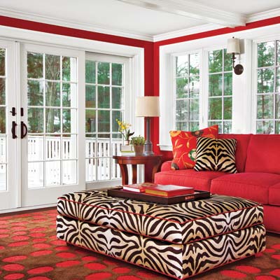 Sunporch after renovation expanded into larger sunroom with walls of windows.