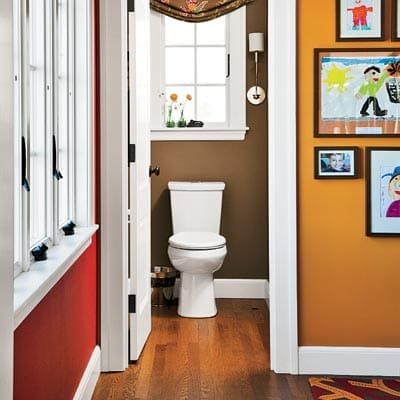 Downstairs powder room after renovation with deep warm tones and coordinated window treatments.