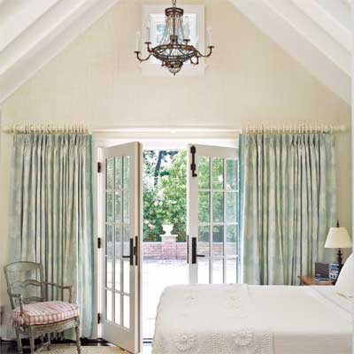 Bedroom with a vaulted ceiling and French doors