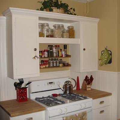 Renovated 10-by-12-foot kitchen with painted metal cabinets.