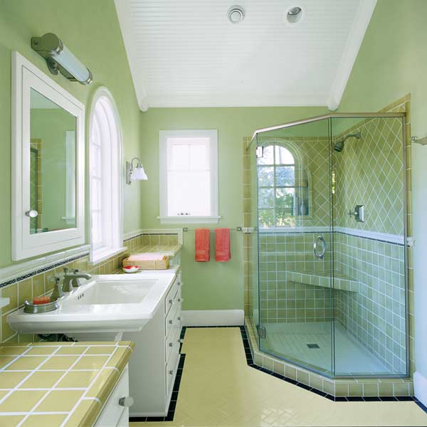 Small green bathroom with built-in storage.