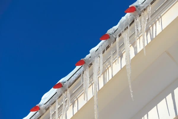 Light strands with icicles hanging off of them on the side of a house.