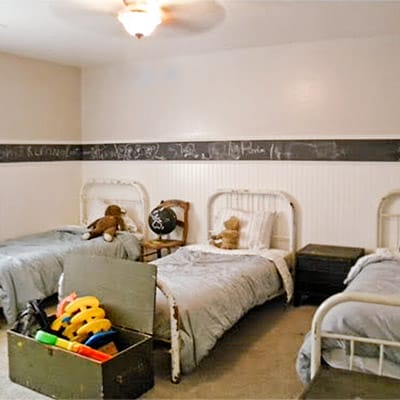 Boys bedroom before renovation with three separate twin beds taking floor space.