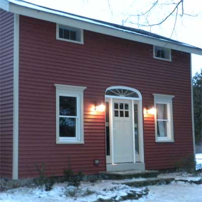 The upstate New York house with a new front door and vinyl siding