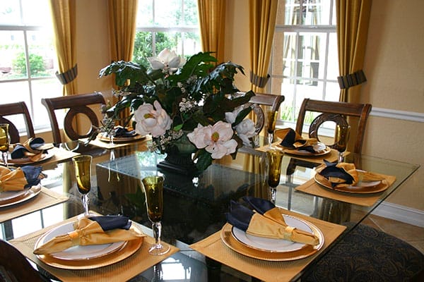 A set dining room table with a floral centerpiece