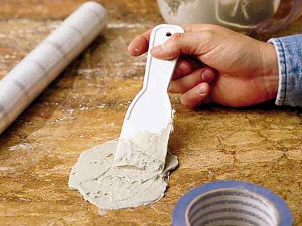 A person cleaning a stain off of a surface