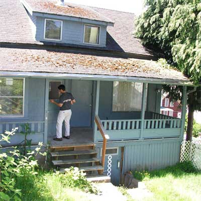 A man standing on the porch of a house in California