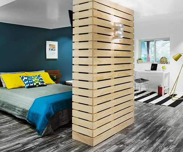Boxed metal support column transformed into functional dividing wall.