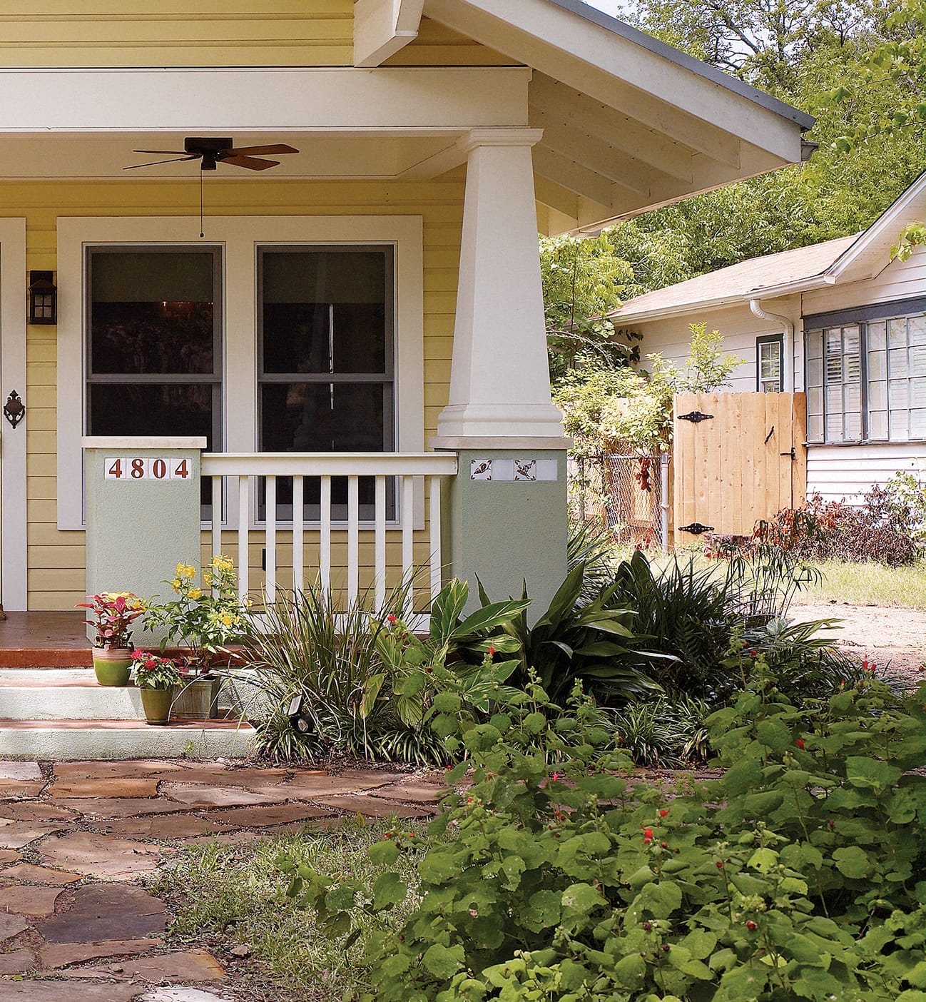 Drought-tolerant landscaping around the yellow cottage.