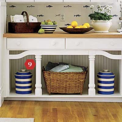 Kitchen cabinet with decorative moldings and beadboard backing detail.