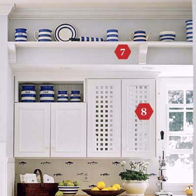 Cottage kitchen with high plate rail and lattice cabinet door inserts.