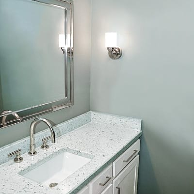 Modern powder room with cool-tone accents.